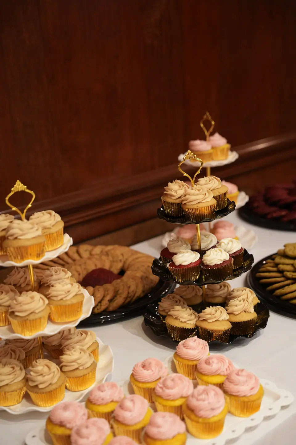 Cupcakes and pastries arranged on tiered dessert stands